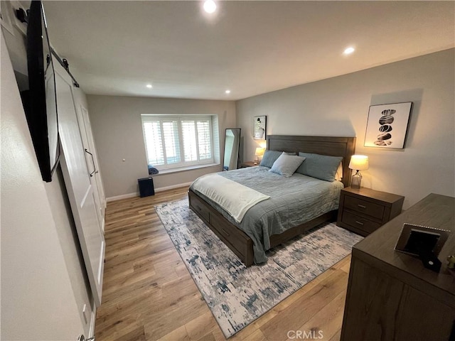9749 Reseda Blvd Unit 13, Northridge, CA 91324 - bedroom featuring a barn door, light wood finished floors, and recessed lighting
