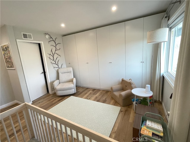 9749 Reseda Blvd Unit 13, Northridge, CA 91324 - bedroom featuring light wood-type flooring, recessed lighting, and a crib