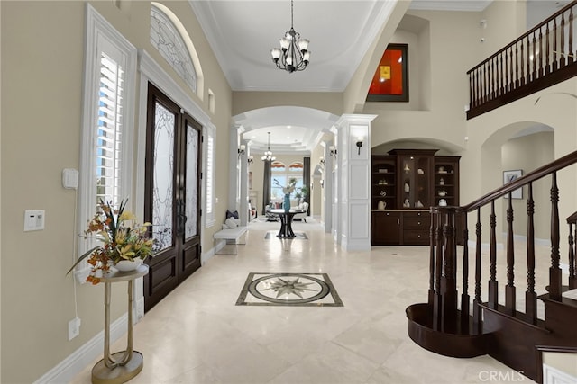15841 Aurora Crest Dr, Whittier, CA 90605 - entrance foyer with arched walkways, a chandelier, ornamental molding, ornate columns, and stairs