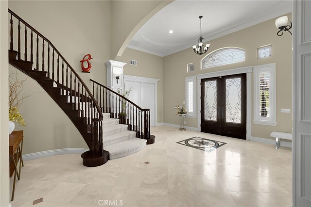 15841 Aurora Crest Dr, Whittier, CA 90605 - foyer with a towering ceiling, arched walkways, stairway, ornamental molding, and a chandelier