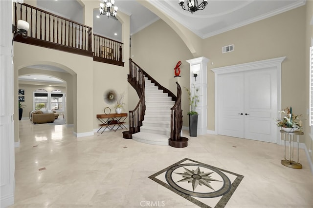 15841 Aurora Crest Dr, Whittier, CA 90605 - foyer featuring arched walkways, a towering ceiling, a chandelier, stairway, and crown molding