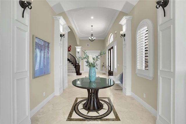 15841 Aurora Crest Dr, Whittier, CA 90605 - foyer entrance with ornate columns, crown molding, stairs, arched walkways, and a chandelier