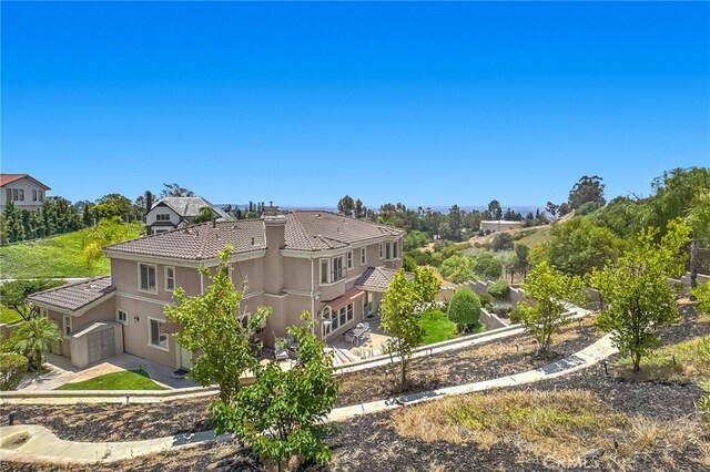 15841 Aurora Crest Dr, Whittier, CA 90605 - rear view of property featuring a tile roof, stucco siding, and a chimney