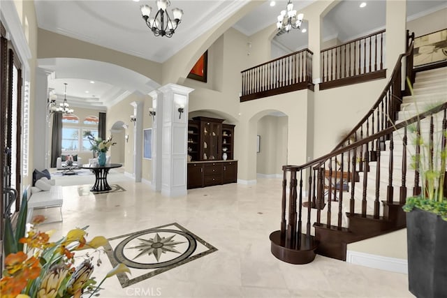15841 Aurora Crest Dr, Whittier, CA 90605 - entryway with a chandelier, arched walkways, ornamental molding, decorative columns, and stairs