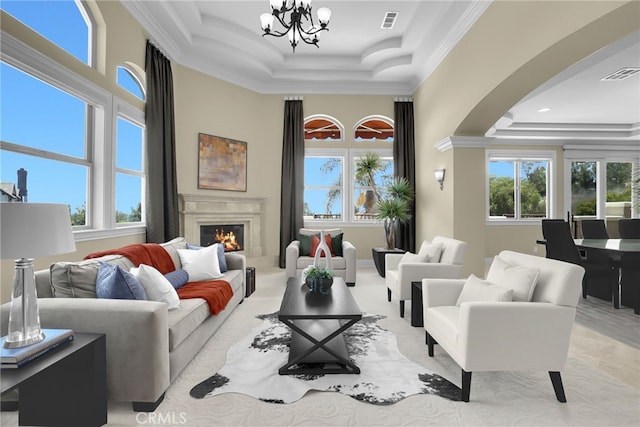 15841 Aurora Crest Dr, Whittier, CA 90605 - living room featuring a tray ceiling, crown molding, arched walkways, and plenty of natural light