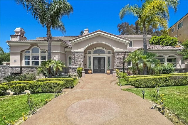 15841 Aurora Crest Dr, Whittier, CA 90605 - view of front of property featuring french doors, stucco siding, a chimney, and stone siding