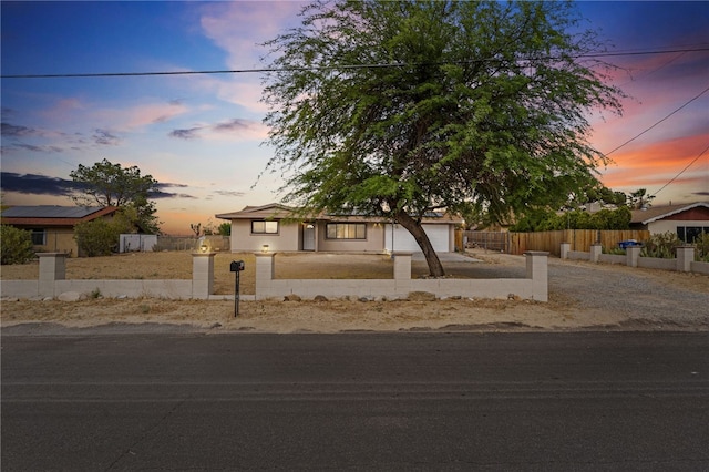 7115 Rubidoux Ave, Yucca Valley, CA 92284 - view of front of property featuring a fenced front yard, driveway, and an attached garage