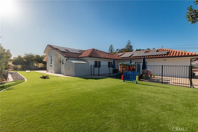 395 Mesa Rd, Nipomo, CA 93444 - rear view of house featuring solar panels, a fenced backyard, stucco siding, a tile roof, and a patio