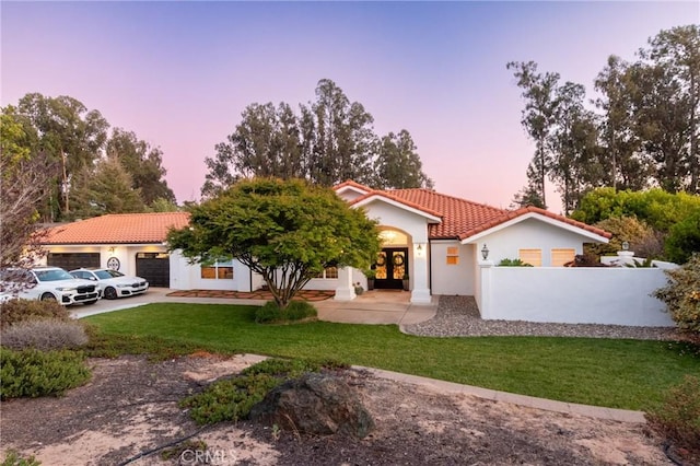 395 Mesa Rd, Nipomo, CA 93444 - mediterranean / spanish home with a tiled roof, an attached garage, stucco siding, french doors, and a front lawn