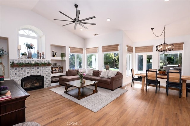 395 Mesa Rd, Nipomo, CA 93444 - living room featuring vaulted ceiling, a fireplace, healthy amount of natural light, light wood-type flooring, and ceiling fan