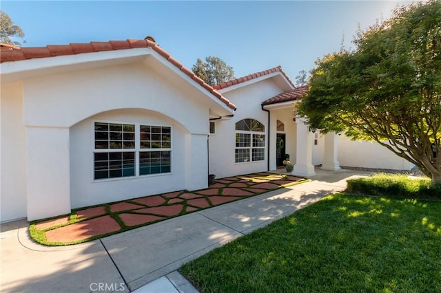 395 Mesa Rd, Nipomo, CA 93444 - property entrance with a tile roof, a patio, stucco siding, and a yard