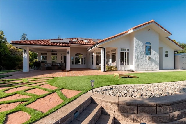 395 Mesa Rd, Nipomo, CA 93444 - back of house featuring a ceiling fan, an outdoor living space, a tiled roof, solar panels, and a yard