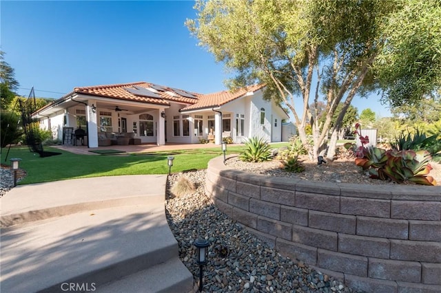 395 Mesa Rd, Nipomo, CA 93444 - back of house featuring a ceiling fan, roof mounted solar panels, a lawn, a tiled roof, and a patio area