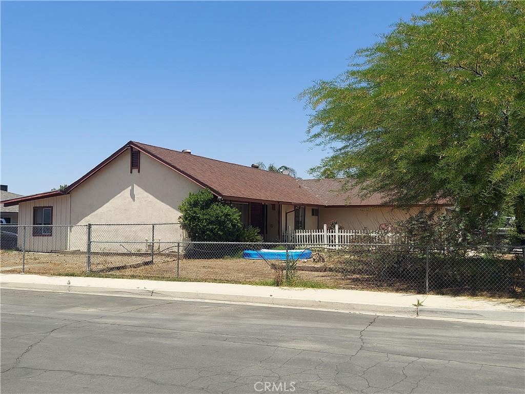 ranch-style home with a garage and a fenced front yard