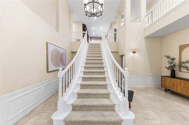 23665 Ridgecrest Ct, Diamond Bar, CA 91765 - stairs with a decorative wall, a high ceiling, wainscoting, and a chandelier