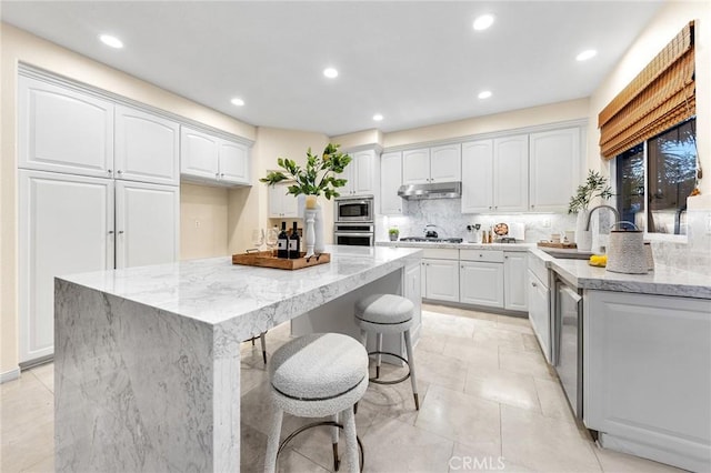 23665 Ridgecrest Ct, Diamond Bar, CA 91765 - kitchen featuring stainless steel appliances, light stone countertops, backsplash, recessed lighting, and a kitchen island