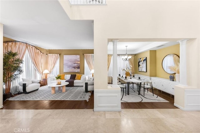 23665 Ridgecrest Ct, Diamond Bar, CA 91765 - living room with ornate columns, healthy amount of natural light, a chandelier, a decorative wall, and wood finished floors
