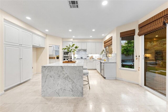 23665 Ridgecrest Ct, Diamond Bar, CA 91765 - kitchen featuring appliances with stainless steel finishes, white cabinetry, a center island, light stone counters, and recessed lighting