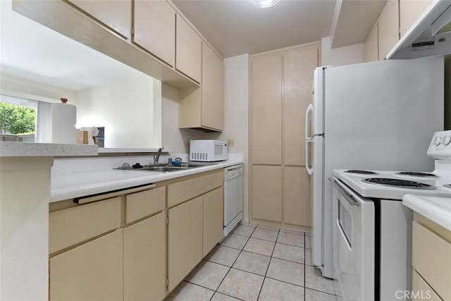 23326 Sesame St Unit E, Torrance, CA 90502 - kitchen featuring white appliances, under cabinet range hood, light countertops, cream cabinetry, and light tile patterned flooring