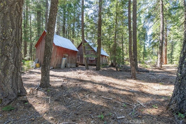 7472 Humboldt Rd, Butte Meadows, CA 95942 - view of yard with an outbuilding, a view of trees, and a barn