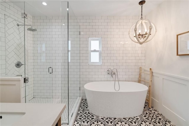 1722 Harper Ave, Redondo Beach, CA 90278 - bathroom featuring a stall shower, tile patterned floors, a freestanding bath, a chandelier, and tile walls
