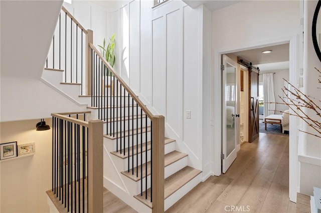 1722 Harper Ave, Redondo Beach, CA 90278 - stairs with wood finished floors, a barn door, and recessed lighting