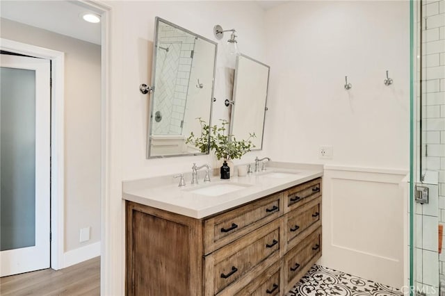 1722 Harper Ave, Redondo Beach, CA 90278 - bathroom featuring double vanity, a tile shower, and wood finished floors