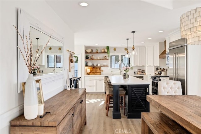 1722 Harper Ave, Redondo Beach, CA 90278 - kitchen featuring stainless steel appliances, light wood-style flooring, white cabinetry, light countertops, and backsplash