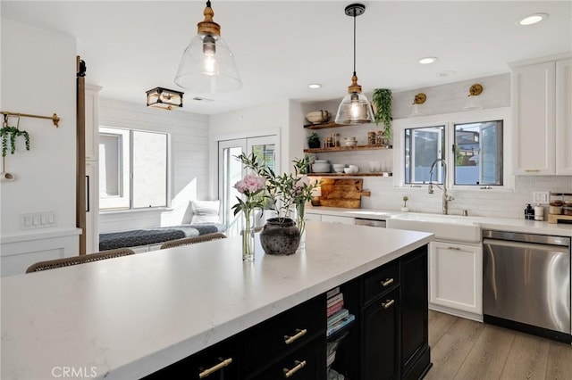 1722 Harper Ave, Redondo Beach, CA 90278 - kitchen with stainless steel dishwasher, white cabinets, backsplash, dark cabinetry, and light wood-style floors