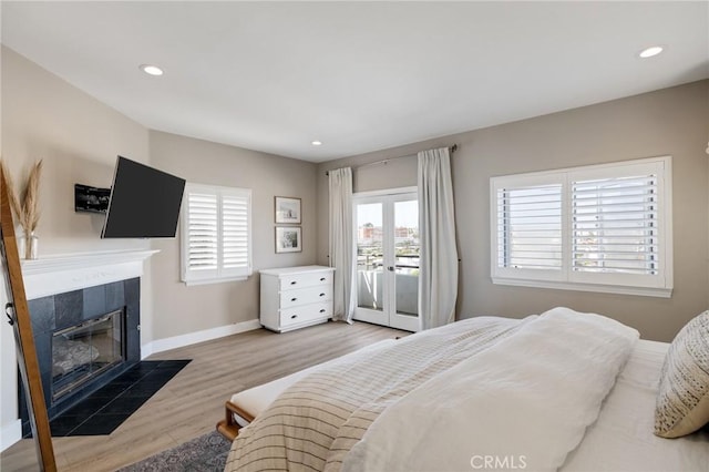 1722 Harper Ave, Redondo Beach, CA 90278 - bedroom with access to outside, light wood finished floors, a tiled fireplace, recessed lighting, and french doors