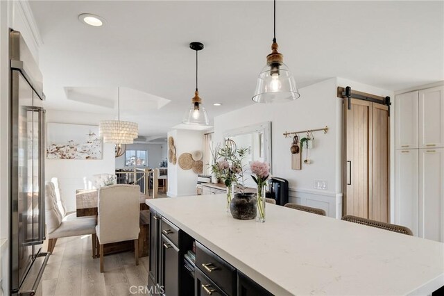 1722 Harper Ave, Redondo Beach, CA 90278 - kitchen featuring high quality fridge, a barn door, dark cabinets, a kitchen island, and light wood-style floors