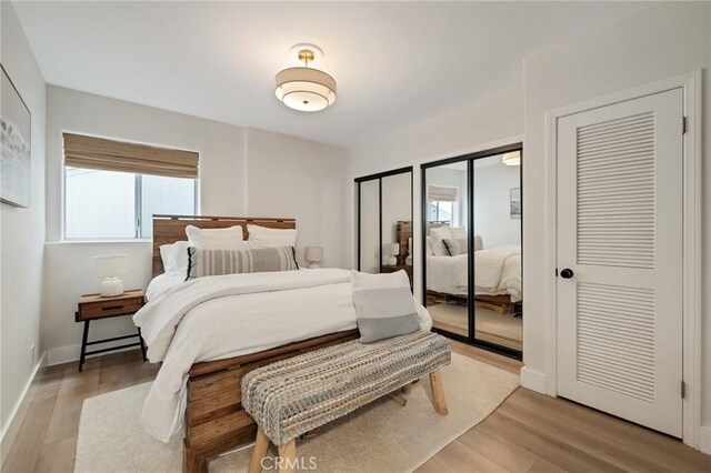 1722 Harper Ave, Redondo Beach, CA 90278 - bedroom with multiple windows, light wood-type flooring, and two closets
