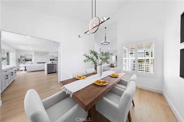 25885 Astor Way, Lake Forest, CA 92630 - dining area with a chandelier, light wood-style floors, a high ceiling, and recessed lighting