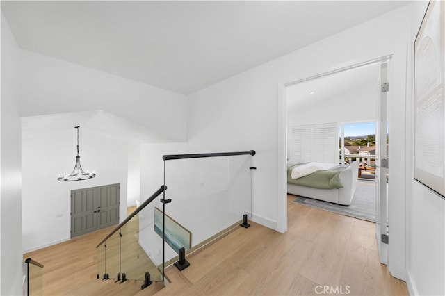 25885 Astor Way, Lake Forest, CA 92630 - corridor featuring an upstairs landing, light wood-style floors, and a chandelier