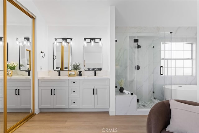 25885 Astor Way, Lake Forest, CA 92630 - full bathroom with double vanity, a marble finish shower, a soaking tub, and wood finished floors