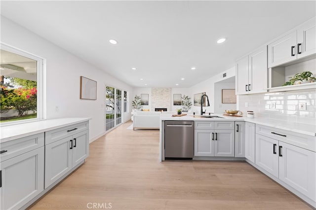 25885 Astor Way, Lake Forest, CA 92630 - kitchen with dishwasher, open shelves, a peninsula, light wood-type flooring, and light countertops