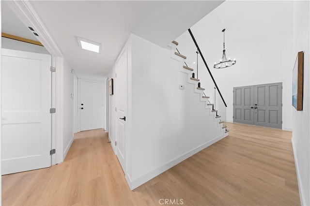 25885 Astor Way, Lake Forest, CA 92630 - hall featuring light wood finished floors, stairs, and a chandelier