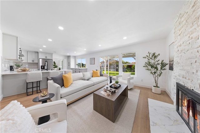 25885 Astor Way, Lake Forest, CA 92630 - living area with recessed lighting, light wood-type flooring, and a premium fireplace