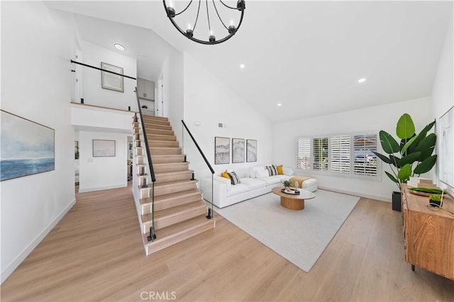 25885 Astor Way, Lake Forest, CA 92630 - living room with high vaulted ceiling, light wood-style flooring, stairs, a chandelier, and recessed lighting