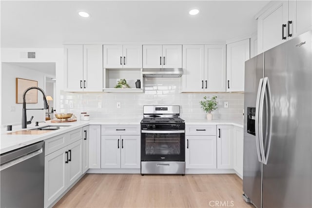 25885 Astor Way, Lake Forest, CA 92630 - kitchen featuring appliances with stainless steel finishes, range hood, white cabinetry, light countertops, and recessed lighting