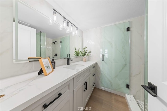 25885 Astor Way, Lake Forest, CA 92630 - bathroom with vanity, a marble finish shower, and wood finished floors
