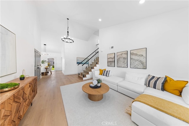 25885 Astor Way, Lake Forest, CA 92630 - living area with light wood-style floors, stairs, recessed lighting, a chandelier, and high vaulted ceiling