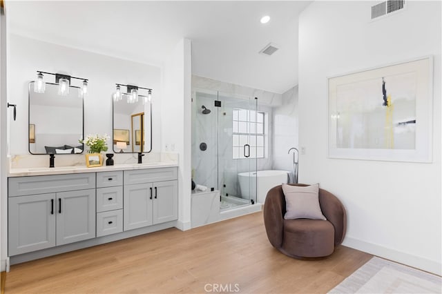 25885 Astor Way, Lake Forest, CA 92630 - full bath featuring double vanity, wood finished floors, a soaking tub, a stall shower, and vaulted ceiling