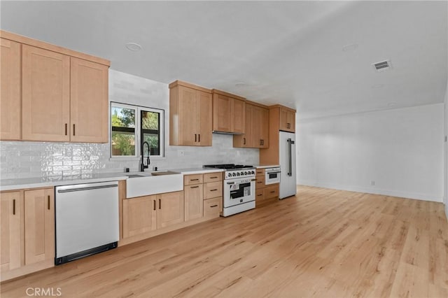 151 Barret Rd, Riverside, CA 92507 - kitchen featuring high quality appliances, light brown cabinets, backsplash, and light wood finished floors