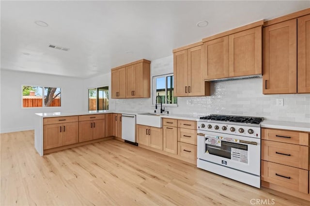 151 Barret Rd, Riverside, CA 92507 - kitchen with white appliances, a peninsula, light wood finished floors, decorative backsplash, and light countertops