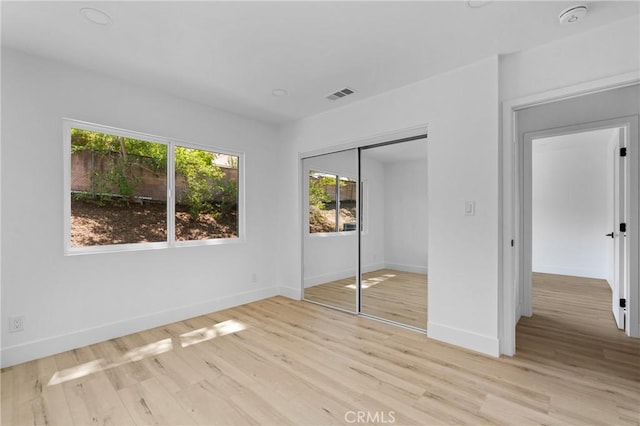 151 Barret Rd, Riverside, CA 92507 - unfurnished bedroom with multiple windows, light wood finished floors, and a closet