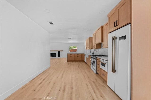 151 Barret Rd, Riverside, CA 92507 - kitchen with high quality appliances, light wood-style flooring, tasteful backsplash, and open floor plan