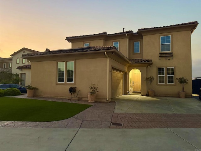 1349 Pyramid Peak St, Chula Vista, CA 91913 - mediterranean / spanish-style house featuring driveway, a tiled roof, a garage, and stucco siding