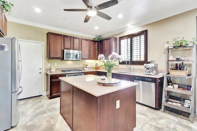 1349 Pyramid Peak St, Chula Vista, CA 91913 - kitchen with appliances with stainless steel finishes, ornamental molding, a ceiling fan, a center island, and light stone countertops