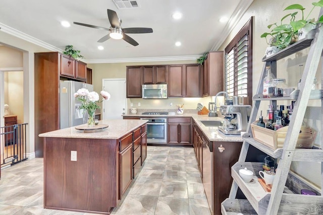 1349 Pyramid Peak St, Chula Vista, CA 91913 - kitchen featuring stainless steel appliances, a ceiling fan, a kitchen island, light stone countertops, and crown molding